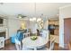 Open-concept living area with hardwood floors connects the kitchen, dining area, and fireplace with bright, natural light at 8009 Whitehawk Hill Rd, Waxhaw, NC 28173