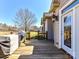 View of the back deck with grill, overlooking the lawn and treeline in the background at 816 Springs Rd, Dallas, NC 28034