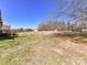 Expansive backyard showcasing open grassy areas and views of the surrounding trees at 816 Springs Rd, Dallas, NC 28034