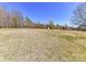 Spacious backyard with green grass and view of mature trees at 816 Springs Rd, Dallas, NC 28034