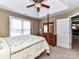 Bedroom with a four-poster bed, dresser, and a view into an adjacent room through an open door at 816 Springs Rd, Dallas, NC 28034