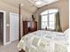 The bedroom is furnished with an armoire, four-poster bed, and a large window at 816 Springs Rd, Dallas, NC 28034