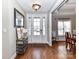 Bright foyer features hardwood floors, a decorative table, and a view into the adjacent dining area at 816 Springs Rd, Dallas, NC 28034