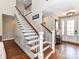 Beautiful foyer area with staircase, hardwood floors, and a lovely entryway door at 816 Springs Rd, Dallas, NC 28034