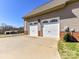 Two-car garage with white doors and brick accents, offering ample parking space at 816 Springs Rd, Dallas, NC 28034