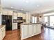 Kitchen with hardwood flooring, granite countertops, kitchen island and stainless steel refrigerator at 816 Springs Rd, Dallas, NC 28034