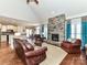 Cozy living room with a stone fireplace, vaulted ceiling, and an open layout at 816 Springs Rd, Dallas, NC 28034