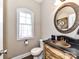 Unique powder room boasts an ornate mirror and stylish vanity with granite countertop at 816 Springs Rd, Dallas, NC 28034