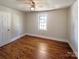 Cozy bedroom featuring hardwood floors, a ceiling fan, and a window at 867 Meadow Hill Ct, Lincolnton, NC 28092