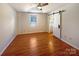 Bright bedroom with hardwood floors, ceiling fan, and barn door leading to the ensuite bathroom, offering comfort at 867 Meadow Hill Ct, Lincolnton, NC 28092