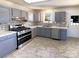 Modern kitchen with stainless steel appliances, gray cabinets, and mosaic tile backsplash at 867 Meadow Hill Ct, Lincolnton, NC 28092