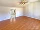 Bright living room featuring hardwood floors, white trim, and a ceiling fan at 867 Meadow Hill Ct, Lincolnton, NC 28092