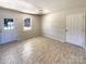 Inviting living room with tile floors, neutral walls, and two exterior doors for access at 867 Meadow Hill Ct, Lincolnton, NC 28092