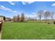This backyard features a large grassy area perfect for games and activities at 8806 Cool Meadow Dr, Huntersville, NC 28078