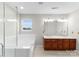 Bathroom featuring a glass shower, tub, and double vanity sink at 8806 Cool Meadow Dr, Huntersville, NC 28078