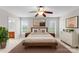 Neutral bedroom with ceiling fan, natural light and ensuite bathroom at 8806 Cool Meadow Dr, Huntersville, NC 28078