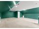 Vast bonus room features dark green walls, carpeted floors, and great natural light at 8806 Cool Meadow Dr, Huntersville, NC 28078