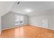 Large bonus room with wood floor, windows and a white door at 8806 Cool Meadow Dr, Huntersville, NC 28078