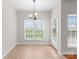 Bright breakfast nook with tile floor, large windows, and modern chandelier at 8806 Cool Meadow Dr, Huntersville, NC 28078
