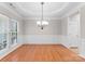 Elegant dining room featuring hardwood floors, decorative molding, and stylish chandelier at 8806 Cool Meadow Dr, Huntersville, NC 28078