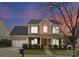 Charming two-story brick home with well-manicured landscaping and inviting front porch at 8806 Cool Meadow Dr, Huntersville, NC 28078