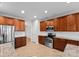 Modern kitchen showcasing stainless steel appliances, granite counters, and hardwood cabinets at 8806 Cool Meadow Dr, Huntersville, NC 28078