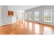 Bright living room featuring hardwood floors and large windows offering abundant natural light at 8806 Cool Meadow Dr, Huntersville, NC 28078