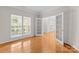 Bright room with hardwood floors, french doors, and large windows overlooking the greenery outside at 8806 Cool Meadow Dr, Huntersville, NC 28078
