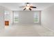 Large main bedroom featuring carpet, a ceiling fan, and windows that provide natural light at 8806 Cool Meadow Dr, Huntersville, NC 28078