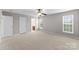 Spacious main bedroom featuring plush carpet, ceiling fan and windows at 8806 Cool Meadow Dr, Huntersville, NC 28078