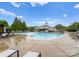 Community pool with clubhouse, lounge chairs, and colorful playground in a well-maintained neighborhood at 8806 Cool Meadow Dr, Huntersville, NC 28078