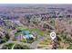 Aerial view of the neighborhood showcasing lush trees, a pool, a pond, and winding streets at 900 Crooked River Dr, Waxhaw, NC 28173