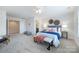 Spacious bedroom with a bed, seating area, and neutral décor at 900 Crooked River Dr, Waxhaw, NC 28173