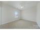 Neutral bedroom features soft carpet, ceiling fan, and inviting natural light at 900 Crooked River Dr, Waxhaw, NC 28173