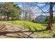 Lush backyard with mature trees and fence line at 9239 Silver Pine Dr, Charlotte, NC 28277