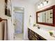 Traditional bathroom with wood-framed mirror and shower featuring patterned curtain at 9239 Silver Pine Dr, Charlotte, NC 28277