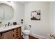 Charming half bathroom with wood vanity, decorative mirror, and elegant fixtures at 9239 Silver Pine Dr, Charlotte, NC 28277