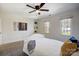 Bright bedroom featuring ceiling fan, two windows and neutral decor at 9239 Silver Pine Dr, Charlotte, NC 28277