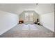 Light-filled bonus room with carpet floor, window, and yoga mats at 9239 Silver Pine Dr, Charlotte, NC 28277