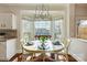 Bright dining area with a round table, chandelier, and large windows offering great views at 9239 Silver Pine Dr, Charlotte, NC 28277