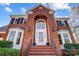 Close up of brick entrance featuring a white door with large window and black iron railing at 9239 Silver Pine Dr, Charlotte, NC 28277