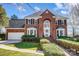 Charming brick home with a two-car garage, manicured shrubs, and a walkway leading to the entrance at 9239 Silver Pine Dr, Charlotte, NC 28277