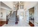 Bright foyer with a staircase, chandelier, and marble floors for an inviting ambiance at 9239 Silver Pine Dr, Charlotte, NC 28277