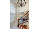 Grand foyer featuring staircase and chandelier with view into formal dining at 9239 Silver Pine Dr, Charlotte, NC 28277