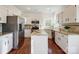 Well-lit kitchen with granite countertops, stainless steel appliances, and a central island at 9239 Silver Pine Dr, Charlotte, NC 28277