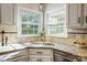 Kitchen sink area features granite countertops and natural light from the adjacent window at 9239 Silver Pine Dr, Charlotte, NC 28277