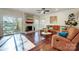 Inviting living room features hardwood floors, a fireplace, and sliding doors to the deck at 9239 Silver Pine Dr, Charlotte, NC 28277