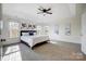 Bright main bedroom with tray ceiling, ceiling fan, and large windows for natural light at 9239 Silver Pine Dr, Charlotte, NC 28277