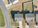 Aerial view of a home, showcasing its roof, driveway, and surrounding yard and neighborhood at 1000 Sweetgum St, Gastonia, NC 28054