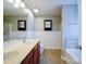 Bathroom featuring a double sink vanity, tile flooring, wood accents and a walk in shower at 1000 Sweetgum St, Gastonia, NC 28054